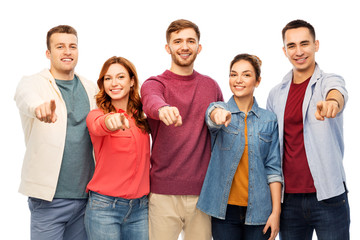 Obraz premium friendship and people concept - group of smiling friends pointing at you over white background