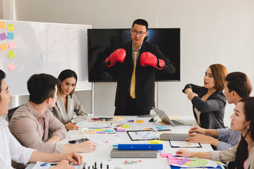 A group of Asian businessmen are discussing their work. Boxing business concept by presendent.