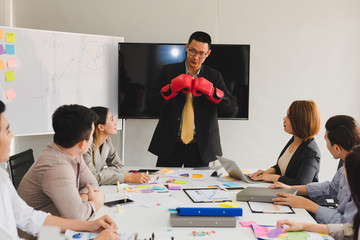 A group of Asian businessmen are discussing their work. Boxing business concept by presendent.