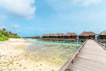 Obraz premium Amazing island in the Maldives ,wooden bridge and beautiful turquoise waters with blue sky background for for holiday ,summer, vacation .