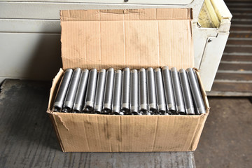 Metal bushings with full-length thread are cardboard boxes in the factory.