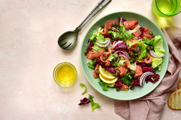 Mix of salad leaves with salted salmon. Top view with copy space.