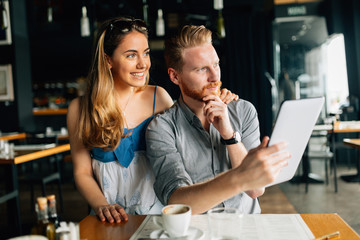 Beautiful couple looking at tablet