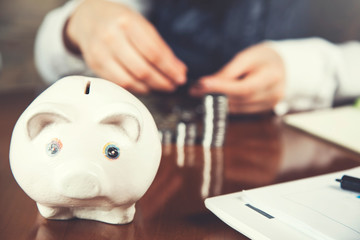 woman hand piggy bank and coins