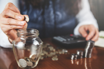 woman hand coins with calculator