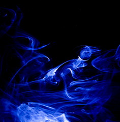 Blue smoke on black background