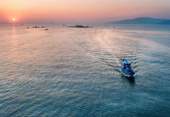 Vietnam, Nha Trang. May 7, 2015. Fishing boat sailing on the sea early in the morning at sunrise