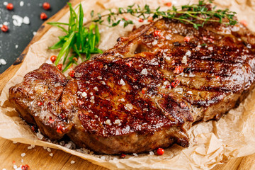 Beef rump steak from marble beef medium rare with sauce on wood plate, close-up. Selective focus.