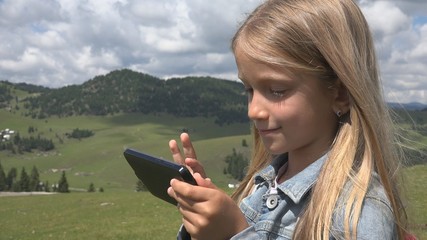 Child Playing Tablet Outdoor in Park, Kid use Smartphone on Meadow Girl in Grass