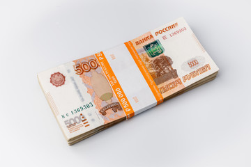 Large stack of banknotes, Russian rubles isolated on white background, packed stack of banknotes 5000 rubles, five hundred thousand