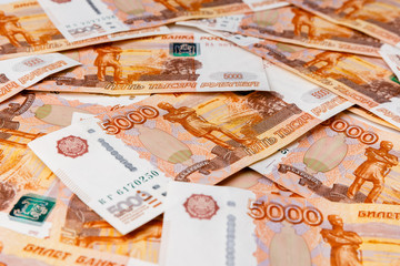 A scattering of many banknotes of five thousand Russian rubles as a background