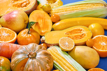 Collection of fresh yellow fruit and vegetables on the blue background - Powered by Adobe