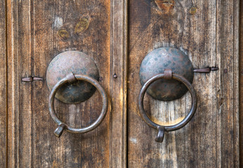 Two round doorknobs  on old wooden door , Bulgaria