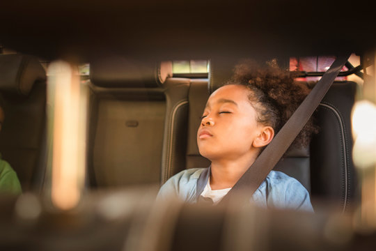 Tired girl sleeping in electric car