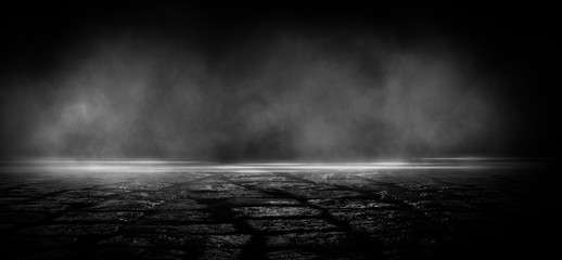 Wet asphalt, reflection of neon lights, a searchlight, smoke. Abstract light in a dark empty street with smoke, smog. Dark background scene of empty street, night view, night city.