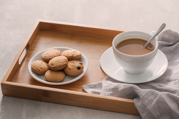 Cup of coffee with milk or cappuccino with cookies on light stone background. Drink with caffeine or cocoa with milk. Coffee break concept.