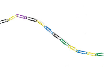 colorful paper clips chain in form of snake on the table surface