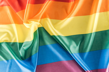 top view of creased rainbow flag, lgbt concept