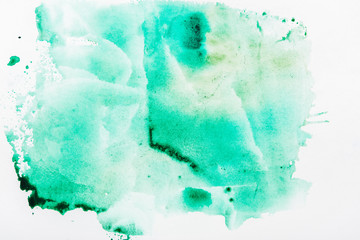 Top view of turquoise watercolor spill on white paper