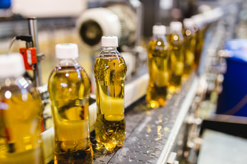 Bottling factory - Apple juice bottling line for processing and bottling juice into bottles. Selective focus.