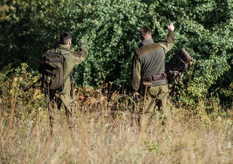 Man hunters with rifle gun. Boot camp. Hunting skills and weapon equipment. How turn hunting into...