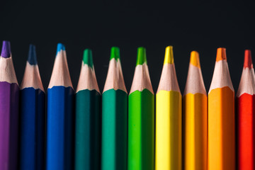 sharpened rainbow multicolored pencils isolated on black, lgbt concept