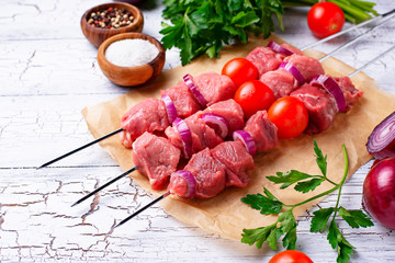 Raw shish kebab skewers  with tomatoes