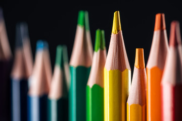 selective focus of rainbow multicolored pencils isolated on black, lgbt concept