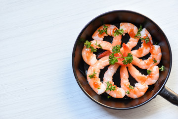 Seafood plate with shrimps prawns ocean gourmet decorate dinner table cooked with sauce herbs and spices on pan