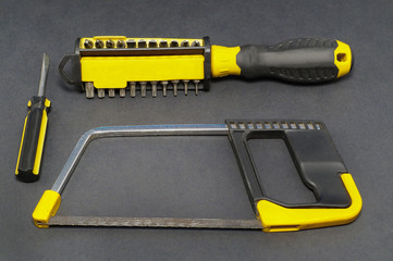 A set of tools on a gray background pliers, screwdriver.