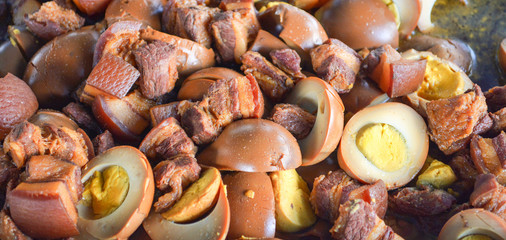 Egg and pork in sweet brown sauce gravy with herb asia food