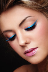 Close-up portrait of young beautiful girl with fancy winged eye make-up