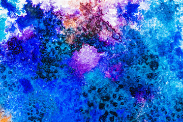 top view of blue and purple watercolor spills with copy space