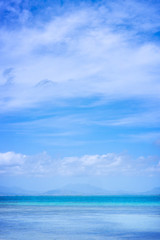 Fototapeta premium Beautiful ocean scene view isolated with light blue sky background, concept of vacation and sea travel, copy space