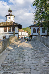 Fototapeta na wymiar Old houses and clock tower in the town of Tryavna