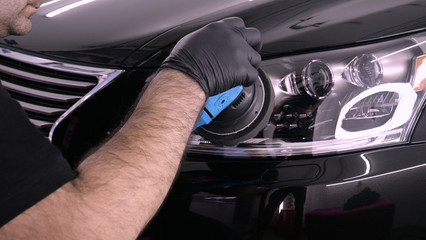 A professional bodywork and headlamp polishing worker will transport the car after painting or...