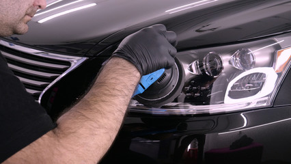 A professional bodywork and headlamp polishing worker will transport the car after painting or...