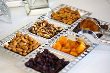 Plate with delicious cheese , nuts, peanuts and raisins
