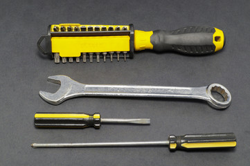 A set of tools on a gray background pliers, screwdriver.