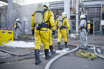 Firefighters and rescuers in a radiation protection, chemical protection suit.