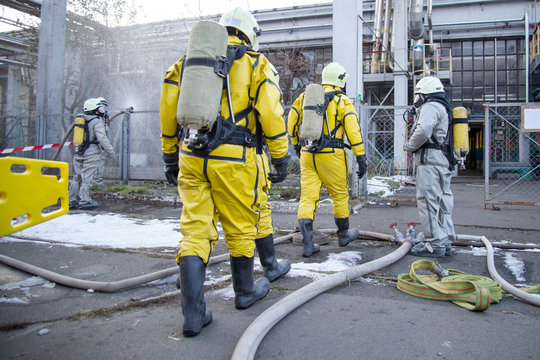 Firefighters and rescuers in a radiation protection, chemical protection suit.