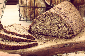 Fresh bread slice and cutting on rustic wooden table