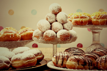 Sweet donuts on rustic wooden table, close up vintage view