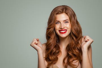 Red head girl with long and shiny curly hair. Happy surprised woman. Expressive facial expressions
