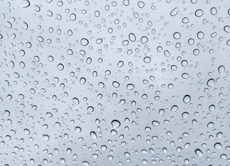 water drops on the car windscreen on rainy and sky as background