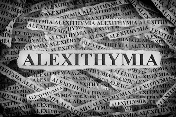 Torn pieces of paper with the words Alexithymia