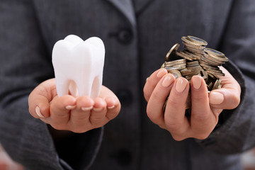 Fototapeta premium Woman Holding Tooth And Coins