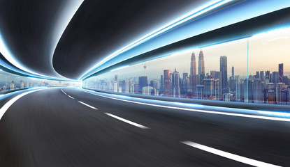 Moving on tunnel with transparent glass window and modern city skyline view . - obrazy, fototapety, plakaty