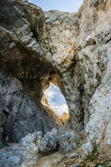 Rock formation with a window in the Julian Alps, Slovenia. This is part of a via ferrata route towards Prisojnik peak, in Triglav National Park.