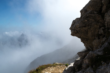 Head silhouette on stone, seen from the side, with clear formations resembling a human nose, lips, eyes and cheeks, found in the Mangart mountain, Julian Alps, Slovenia.  Copy space on the left.